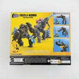 Toy figure packaging with 'Godzilla vs. Kong' branding on a wooden surface